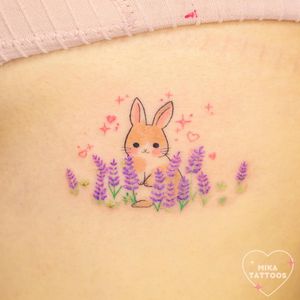 Get inked with a cute anime-style rabbit surrounded by vibrant lavender flowers, brought to life by Mika Tattoos' illustrative skills.