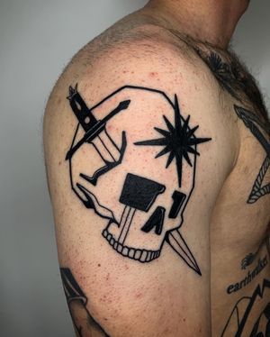 Adrimetric's blackwork tattoo combines a star, skull, and dagger in a bold and illustrative style.