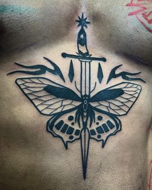 Adrimetric's blackwork tattoo blends a delicate butterfly with a bold sword design for a unique and striking illustrative piece.