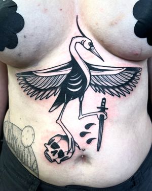 Illustrative tattoo featuring a skull, dagger, crane, and heron by Adrimetric. Bold blackwork design.