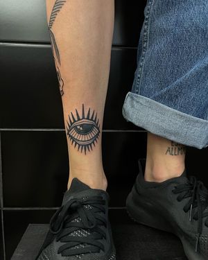 Unique blackwork tattoo featuring an abstract eye design, expertly executed in illustrative style by artist Adrimetric.