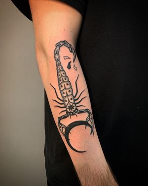Embrace the dark beauty of the moon and the fierce energy of the scorpion with this striking blackwork tattoo by Adrimetric.