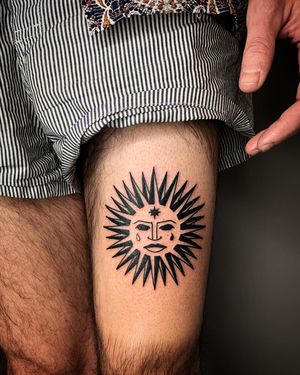 Stunning blackwork tattoo of a sun, expertly crafted by Adrimetric, showcasing intricate design and bold lines.