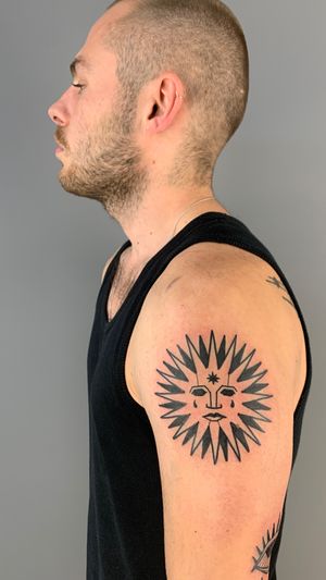 Get a stunning blackwork sun tattoo with intricate details by Adrimetric. Perfect for those who love a bold and artistic look.