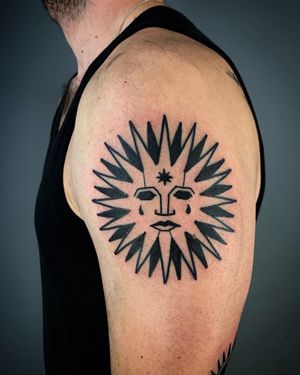 A stunning blackwork illustrative tattoo of a radiant sun, created by the talented artist Adrimetric.