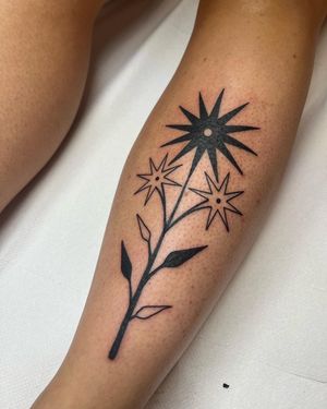 Unique blackwork illustrative tattoo of an abstract flower design by Adrimetric, showcasing intricate linework and shading.