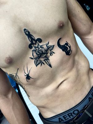 Get a bold and timeless design with this traditional chest tattoo featuring a stunning rose and dagger motif by Miss Vampira.
