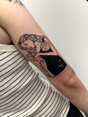 Elegant blackwork tattoo by Miss Vampira, featuring a female figure in a beautiful dress, perfect for upper arm placement.