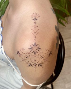 Elegant ornamental pattern design by Indigo Forever Tattoos, perfect for a bold statement on your upper arm.