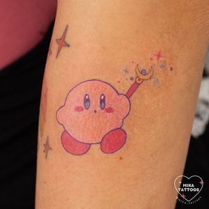 Get a whimsical anime tattoo featuring Kirby and a sailor wand, created by the talented Mika Tattoos.