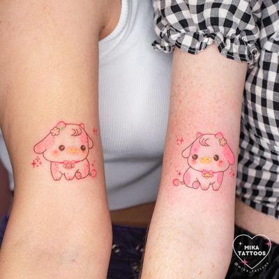 Get a cute and pastel anime tattoo of a strawberry cow done in fine line and watercolor style by Mika Tattoos.