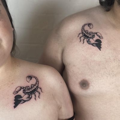 Traditional style chest tattoo by Jenny Dubet featuring a scorpion and half heart motif.