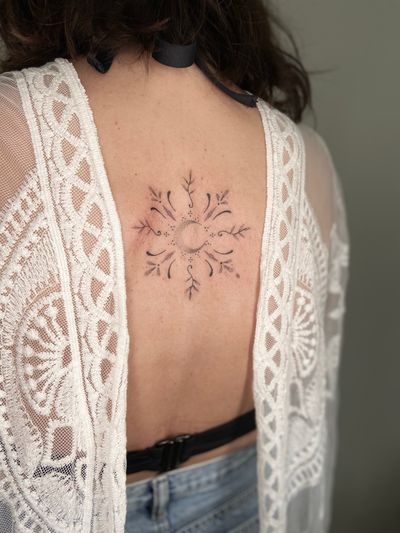 Exquisite dotwork & fine line design by Viví Bogdanov combining moon and leaves motifs on the back.