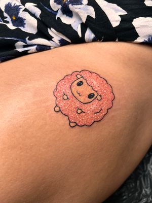 Adorable fine line and illustrative tattoo by Rachel Angharad featuring a cute kawaii sheep design with sparkly glitter accents.