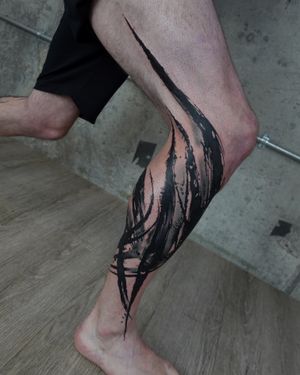 Unique blackwork calf tattoo of a brush motif by Rachel Aspe at Bellatrix Tattoo. Bold and artistic design.