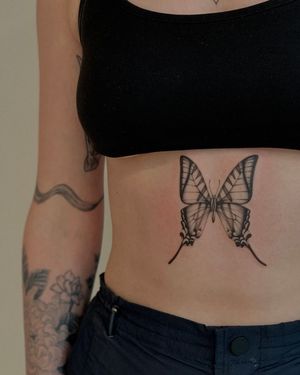 Get a stunning fine line butterfly tattoo by Ophelya Jeandat, perfect for a minimalistic yet artistic touch.
