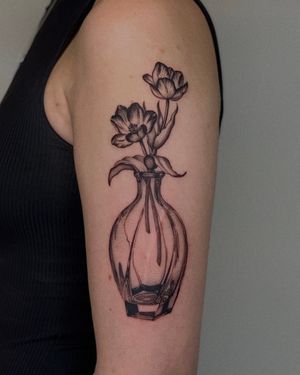 A stunning black and gray micro-realism tattoo of a vintage flower vase, done by the talented artist Ophelya Jeandat.