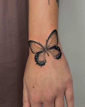 Experience the beauty of fine line and illustrative style with this delicate butterfly tattoo by the talented artist Ophelya Jeandat.
