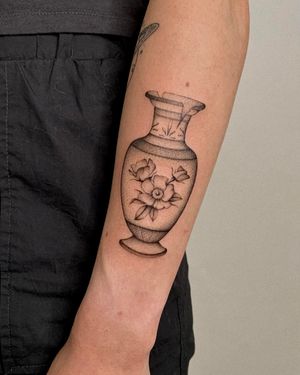 Elegant dotwork style tattoo of a flower in a vase, expertly executed by the talented artist Ophelya Jeandat.