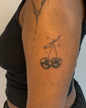 Get a stylish black and gray cherry tattoo by the talented artist Ophelya Jeandat. Perfect for your arm!