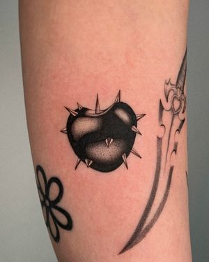 Unique dotwork tattoo by Ophelya Jeandat featuring a heart surrounded by spikes.