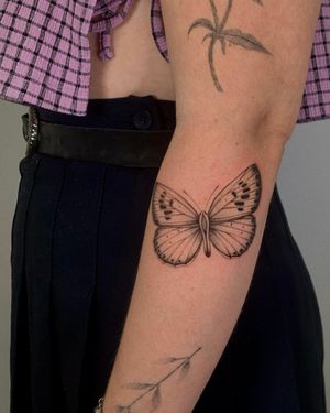 This fine line and illustrative butterfly tattoo by Ophelya Jeandat showcases delicate details and elegant design.