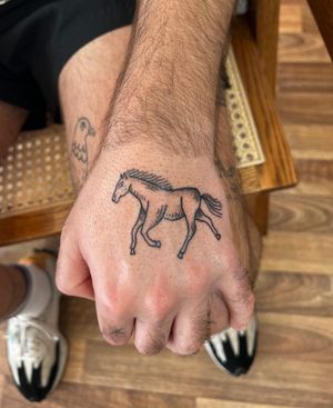 Get a beautifully detailed dotwork horse tattoo on your hand, done by the talented artist Jack Henry.