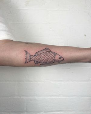 Get a stunning fine line illustrative fish tattoo on your forearm by Jack Henry Tattoo. Perfect for ocean lovers!