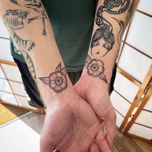 Beautiful blackwork, dotwork, and fine line flower design by Jack Henry Tattoo for a stylish wrist piece.