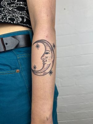 Elegant moon and star design in dotwork and fine line style, beautifully illustrated on the forearm by Jack Henry.