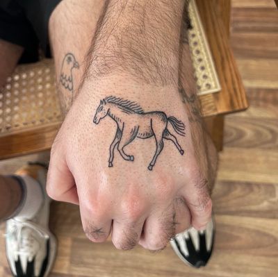 Get a unique dotwork horse tattoo on your hand by Jack Henry Tattoo for a striking and detailed design.
