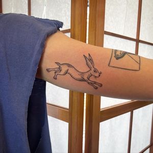 Adorn your arm with a unique illustrative rabbit design by the talented tattoo artist Jack Henry. Stand out with this beautiful and detailed tattoo.