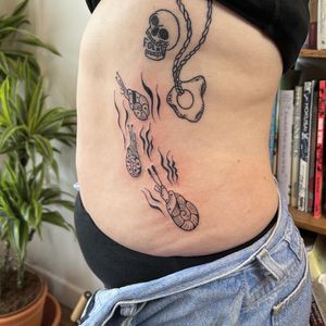 Get a stunning blackwork tattoo of a sea snail on your ribs by the talented artist Jack Henry Tattoo. A unique and intricate design that will make a bold statement.
