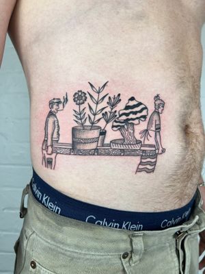 Illustrative fine line tattoo on stomach by Jack Henry Tattoo featuring a beautiful flower with an old man and woman.