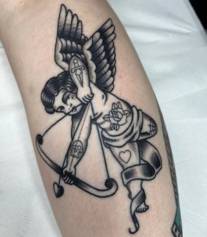 Get inked with a timeless traditional style cupid design by the talented artist Barney Coles. Show off your love for classic tattoos!