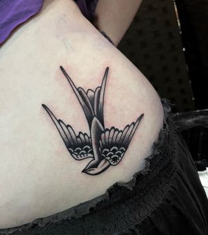 Get timeless tradition with this swallow tattoo by renowned artist Barney Coles. Bold lines and vibrant colors make this a standout piece.