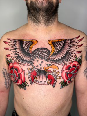 Experience the raw power and beauty of a traditional eagle motif masterfully inked on your chest by Claudia Trash.