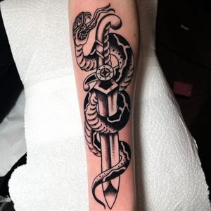 Get inked with the classic combination of a sinister snake and a sharp dagger, expertly done by tattoo artist Barney Coles.