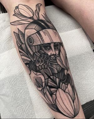 Beautiful dotwork tattoo featuring a race driver and floral motifs on the lower leg by Barney Coles.