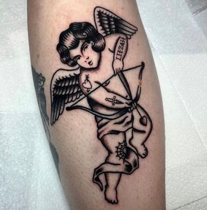 Beautiful traditional tattoo featuring a cherub angel, expertly done by Barney Coles on the calf.