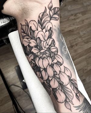 Beautiful peony flower design in dotwork style by Barney Coles, perfect for upper arm placement.