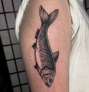 Adorn your arm with a stunning illustrative fish design by the talented Barney Coles. Dive into the depths of elegance with this beautiful tattoo.