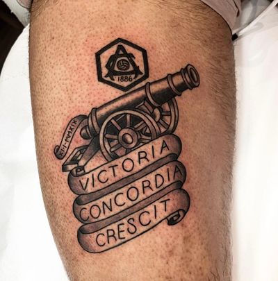 Celebrate your love for Arsenal with this small illustrative tattoo featuring the iconic cannon and logo.