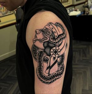Stunning traditional tattoo featuring a snake and woman design by artist Barney Coles. Perfect for arm placement.