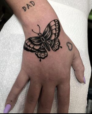 Get inked with a beautiful traditional butterfly design on your hand by artist Barney Coles. Stand out with this timeless piece.