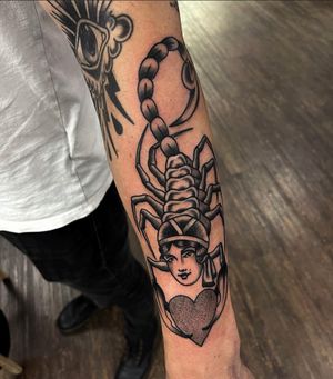 Capture the beauty of a scorpion, heart, and woman in this stunning traditional tattoo by Barney Coles.