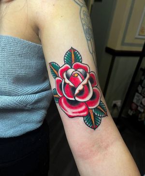 Get a stunning traditional rose tattoo by the talented artist Barney Coles. Classic design with a modern twist. Book your appointment now!