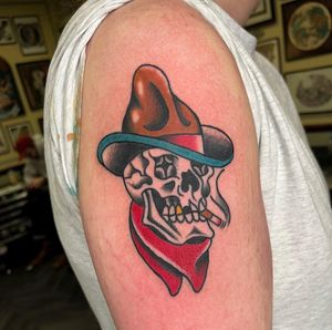 Get inked with a classic skull cowboy design on your arm by Barney Coles. Embrace the wild west with this bold and badass tattoo!