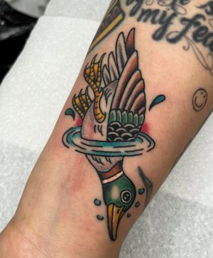 Adorn your lower arm with a stylish neo-traditional duck tattoo by Barney Coles. Embrace the beauty and grace of this intricate design.