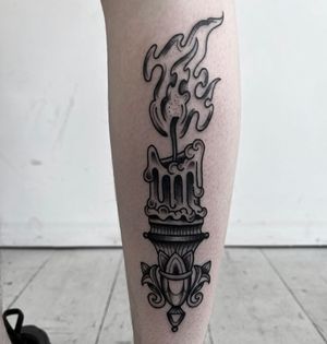Embrace the warmth with this stunning black and gray illustrative tattoo featuring a chandelier, candle, fire, and filigree details, expertly crafted by Barney Coles.